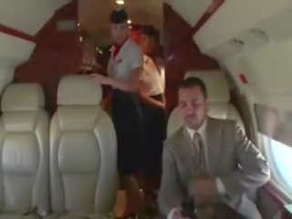 Horny stewardesses suck their clients hard manhood on the plane